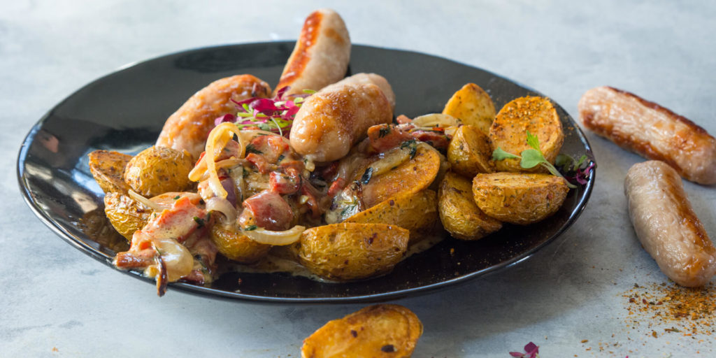 Pork Sausages with Crispy Duck Fat Baby Potatoes & Creamy Red Pepper Sauce