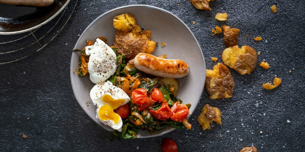 Pork Sausages with Spicy Tomato Spinach & Poached Egg on Crispy Baby Potatoes